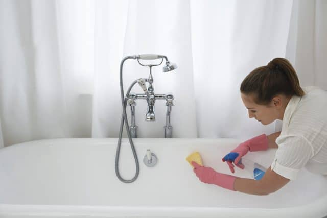 woman cleaning bathub