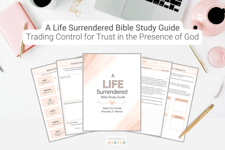 Mockup of A Life Surrendered Bible Study Guide on a desk with a computer, coffee cup, and a pink book