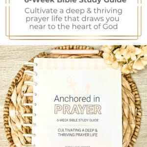 Anchored in Prayer cover on a straw mat with a pink marker and beige flower
