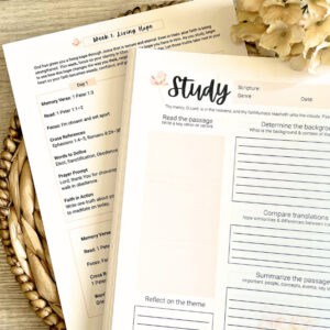 The Rooted Life Bible Study System on a wooden desk with a cream flower